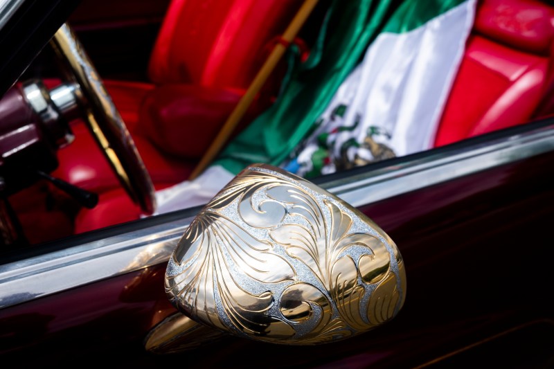 A Mexican flag draped over a car seat.
