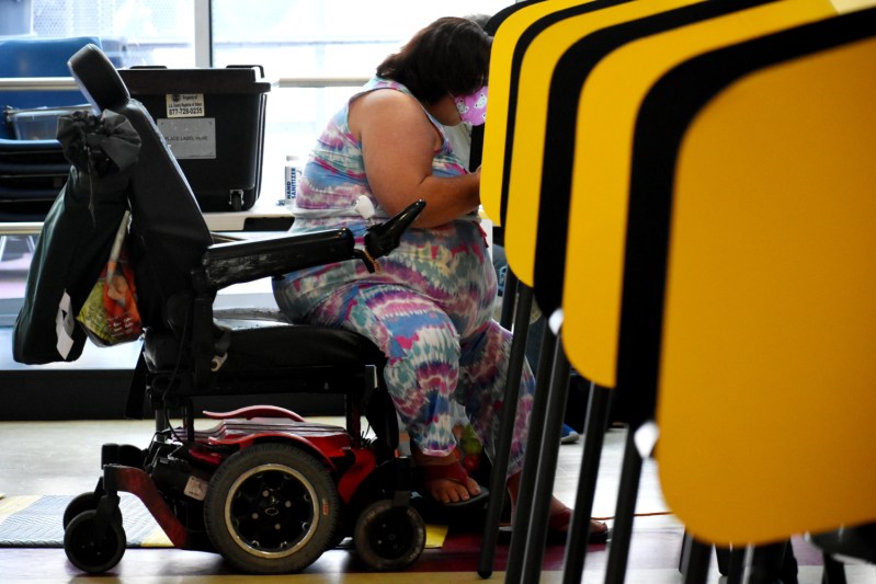 Skid Row resident Micki Gagnon casts her vote in the gubernatorial recall election at her local voting center on Sept. 11, 2021.