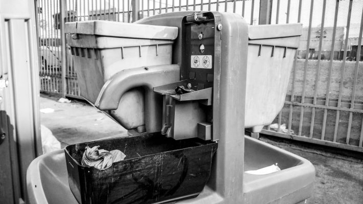 Portable sink in Skid Row missing soap dispenser and water.