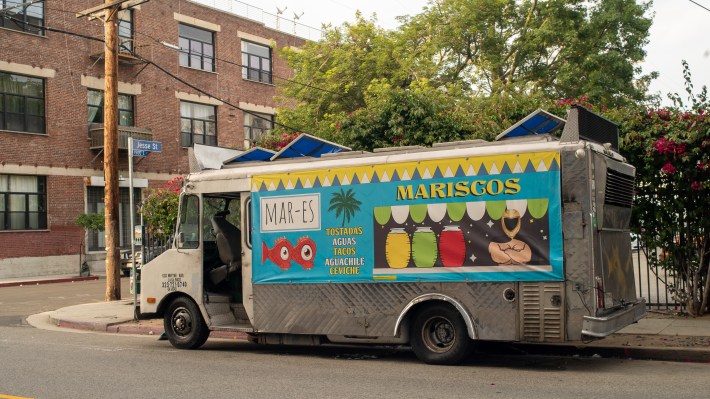 Marcisco Mar-Es's blue and yellow mariscos truck in Downtown L.A.