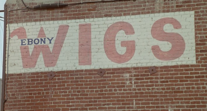 Outside Ebony Wigs, as it appeared in Poetic Justice. Screenshot via Columbia Pictures.