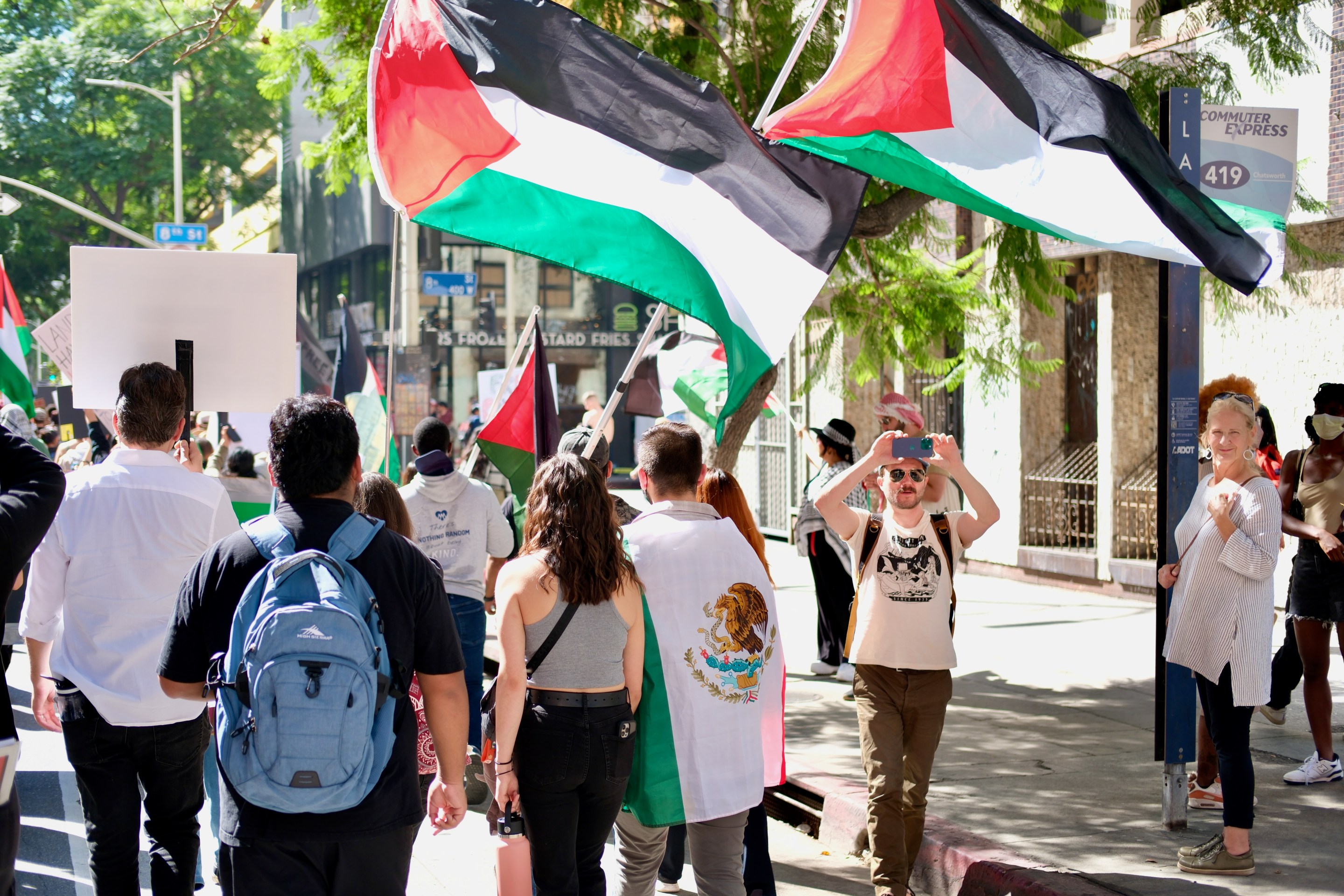 protestors carrying two Palestinian flags