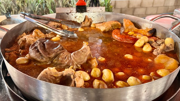 A chorizera pan filled with meats and potatoes