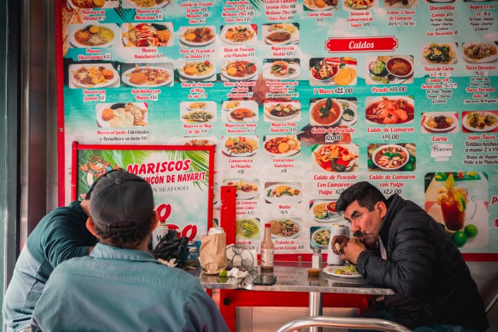 Customers eating at Mariscos El Rincón De Nayarit, Los Angeles, CA