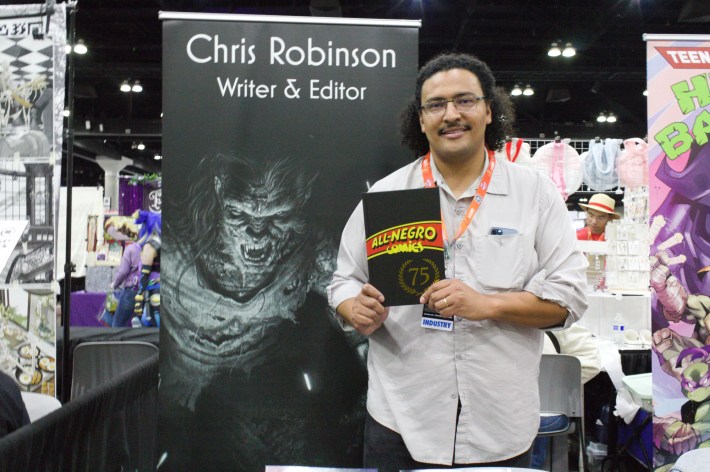 Chris Robinson posing with his comic. Photo by Ivan Fernandez for L.A. TACO.