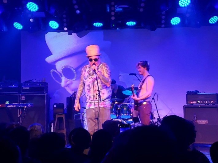 Eric Wilson, bassist for Sublime, having a word with the crowd beside Jakob Nowell at a benefit concert in Downtown Los Angeles