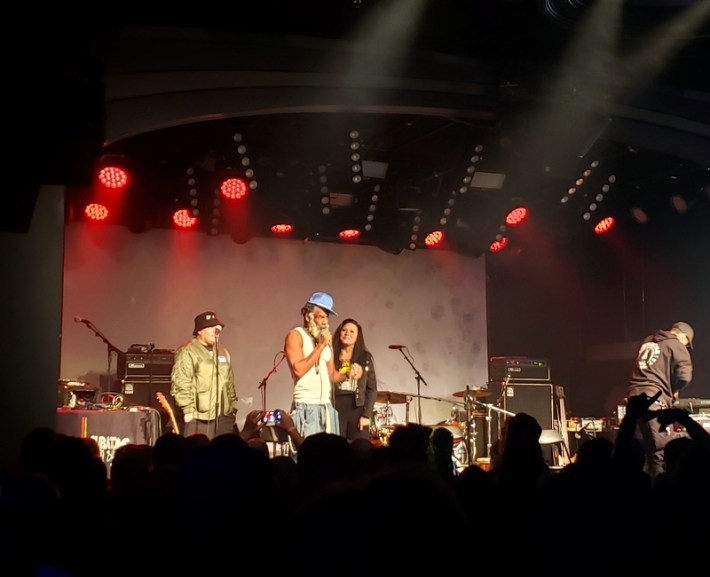 Musician Norwood Fisher (center), with Kentay Fraser (left) and Troy Dendekker (right) introducing a benefit concert for Bad brains singer HR in Los Angeles