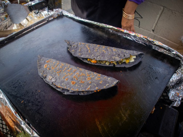 Two sealed blue corn quesadillas on the plancha at Alejandra's in Echo Park