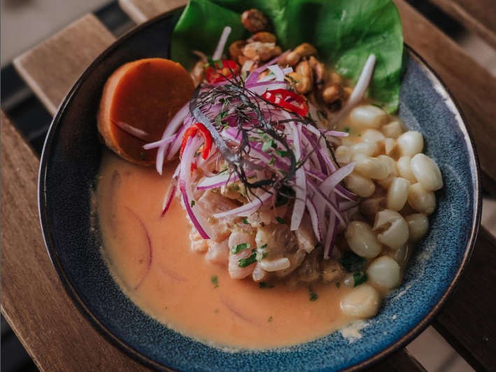 A bowl of ceviche topped with corn and onions at Carmelitas Peruvian in Van Nuys