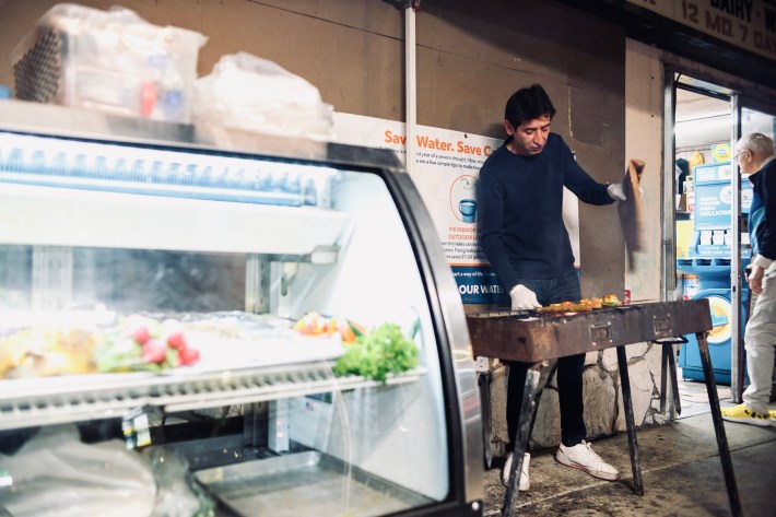 Kebab chef Hussein Akbar cooking kebabs on the West LA sidewalk