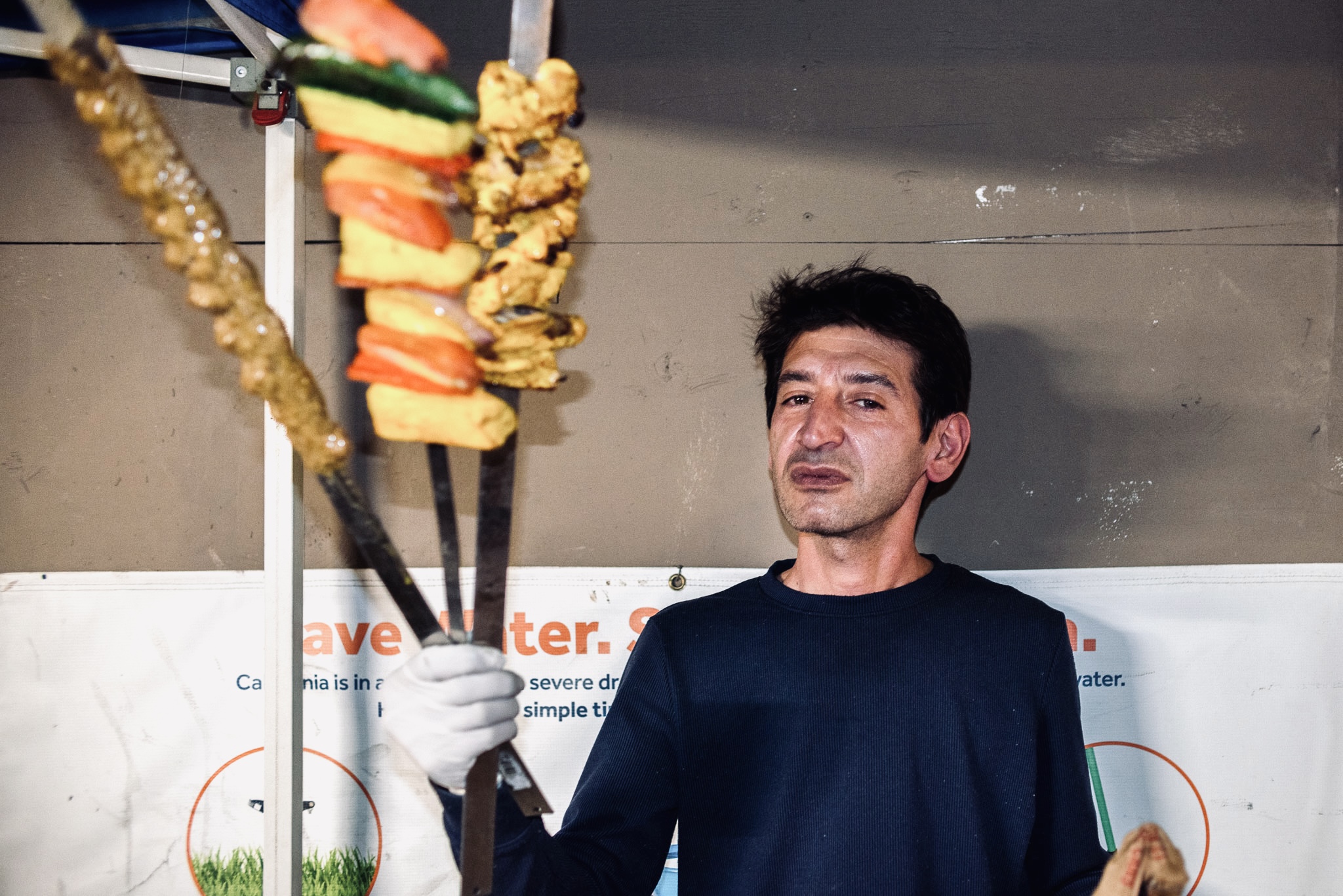 Chef Hussein Akbar holding his koobideh, chicken, and vegetable kebab in West L.A.'s Sawtelle neighborhood