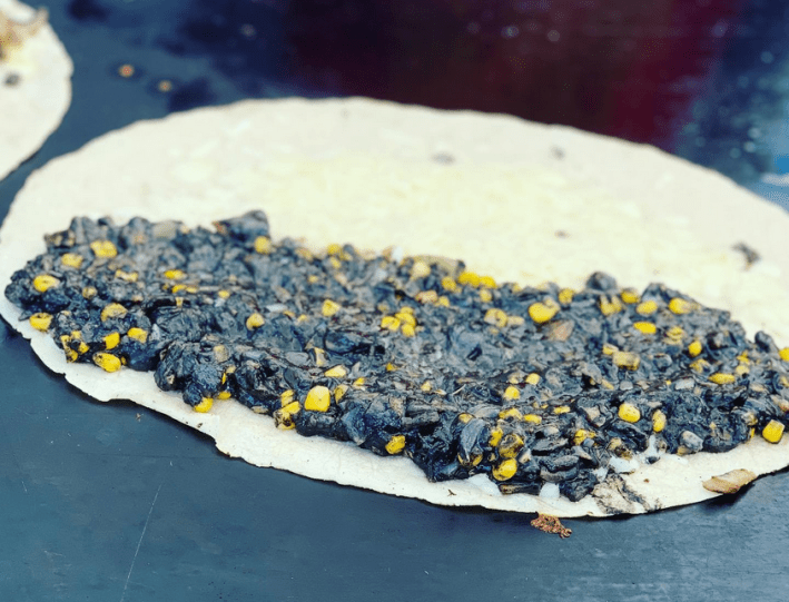 An open quesadilla layered with huitlacoche and corn from Betty's Tacos and Quesadillas