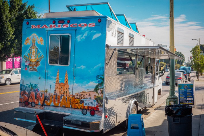 The blue truck of Mariscos San Juan de Los Lagos featuring scenes from the Jalisco town of the same name