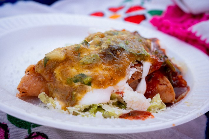 Salsa-drenched tacos dorados from a vendor outside of the Mexican consulate in Westlake, Los Angeles