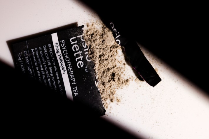 A torn open package of Psilouette's Psychotherapy Tea with powder coming out