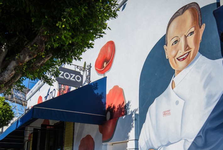 A photo of the entrance to Zozo restaurant, with a mural of Mexican chef Patricia Quintana