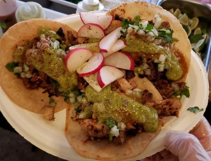 3 tacos on a plate topped with salsa verde