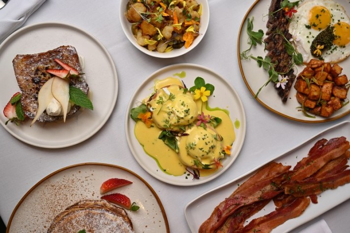 a brunch spread with eggs benedict, bacon, French toast, and steak and eggs from Linden in Hollywood