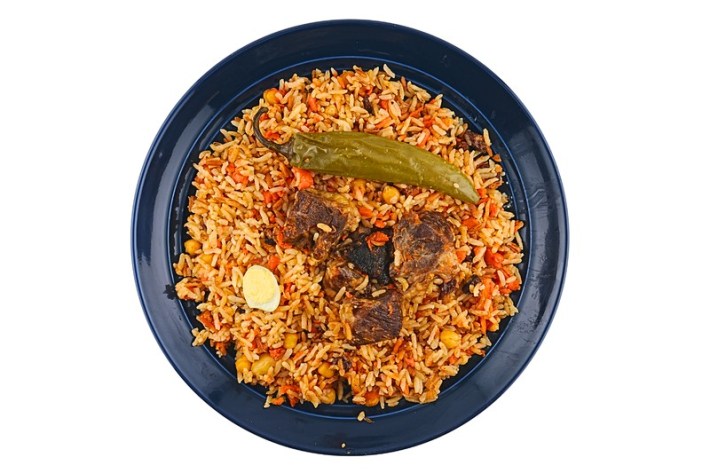 A bowl of Uzebk plov with lamb, rice, and a big green chile