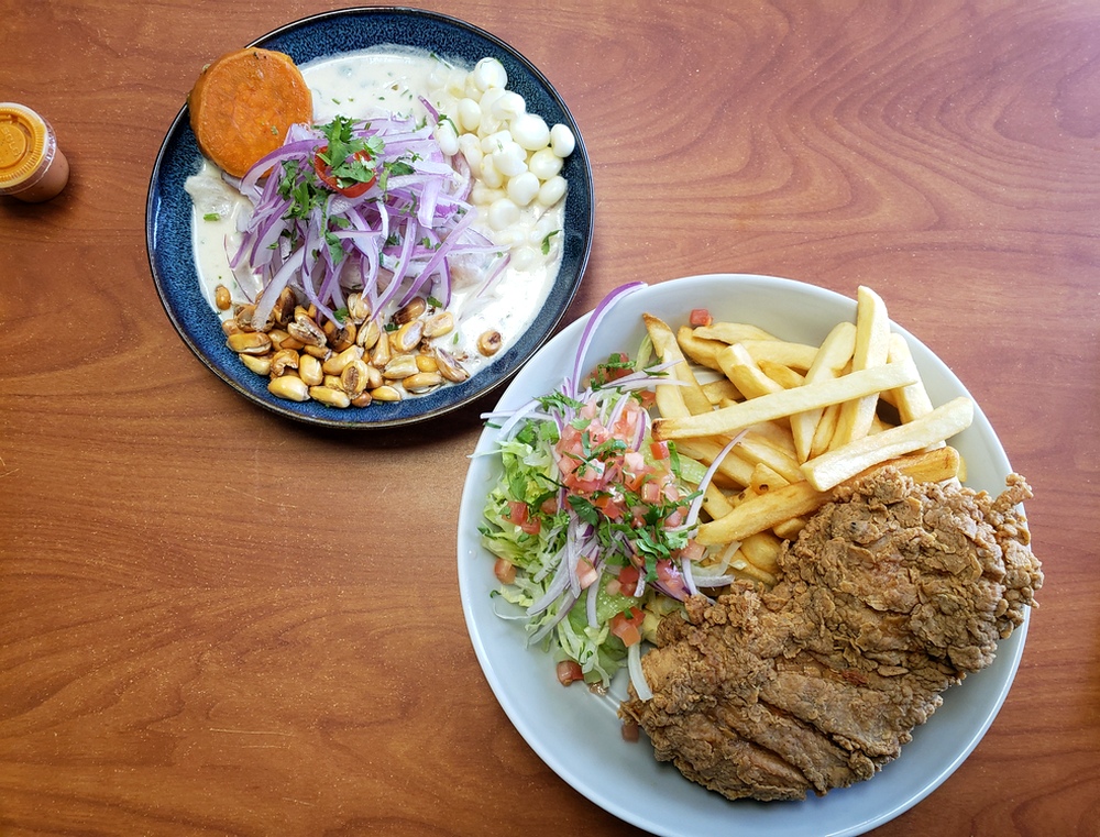 Ceviche de pescado and fried pollo broaster on a table side-by-side