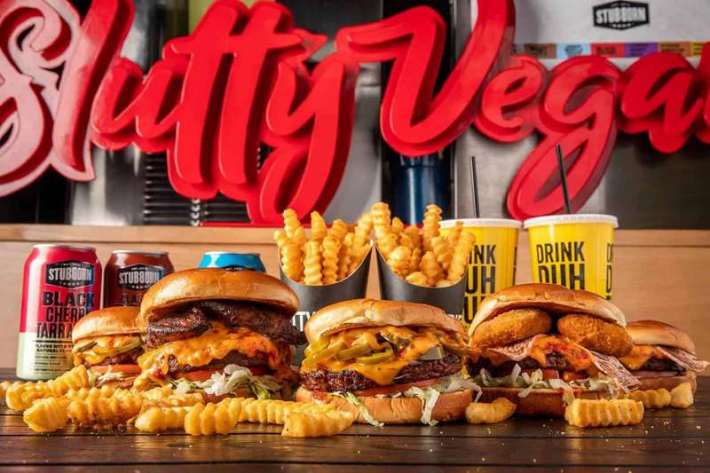 A trio of vegan buirgers backed by fries and sodas