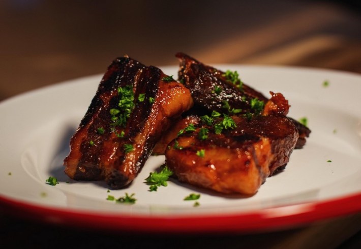 3 cuts of glazed pork belly on a plate