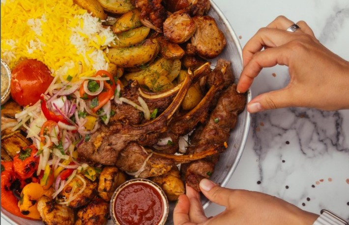 A platter of lamb chops and luleh kebab at Lavshash Kebab, with saffron rice and vegetables.