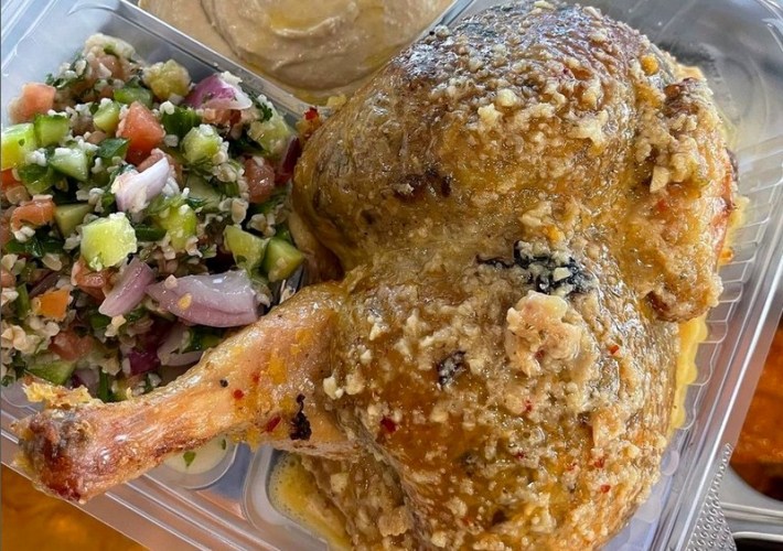 A chicken leg and thigh with a rub of spices at Jerusalem Chicken in Los Angeles