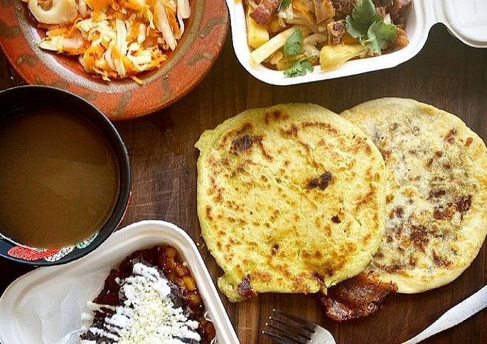 Curtido, pork belly-topped yucca frita, and pupusas at Walking Spanish.