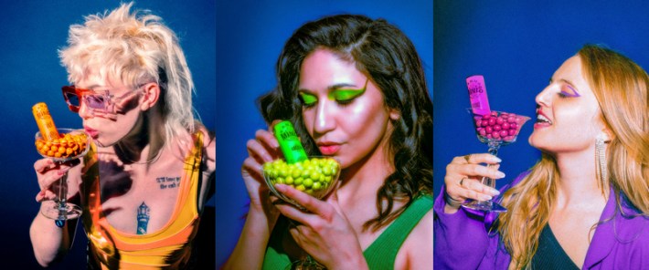 Three colorful women eating Kanha Minis cannabis edibles from glasses.