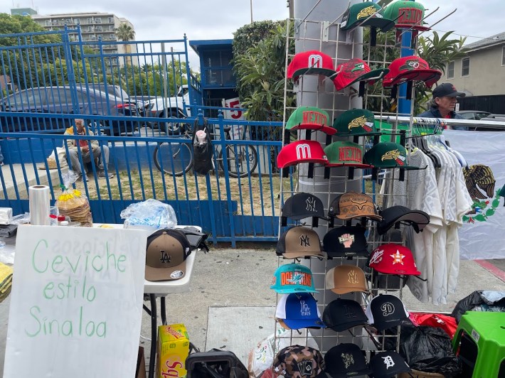 Mexico Hats, jerseys, and ceviche being sold on the street. Photo by Abraham Márquez for L.A. TACO.