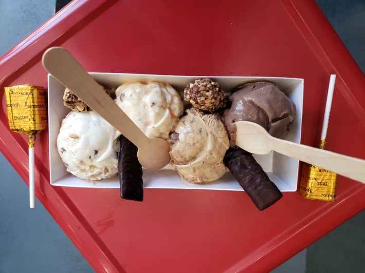 Four flavors of ice cream from the partnership of See's Candy and McConnell's Fine Ice Creams, with candy sticking out