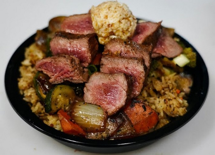 Sliced steak on a rice bowl at Don Bachi