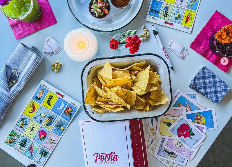 a table with chips, salsas, and Lotería at Pocha restaurant in L.A.