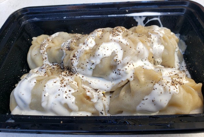 Manti dumplings covered in yogurt sauce and black pepper