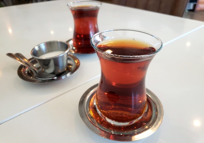 Black tea in glasses, served Turkish-style, with a bowl of sugar