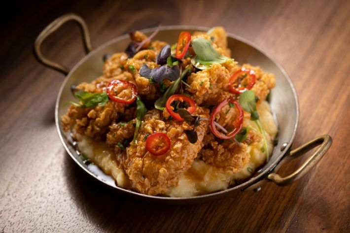 Fried chicken topped with sliced chiles