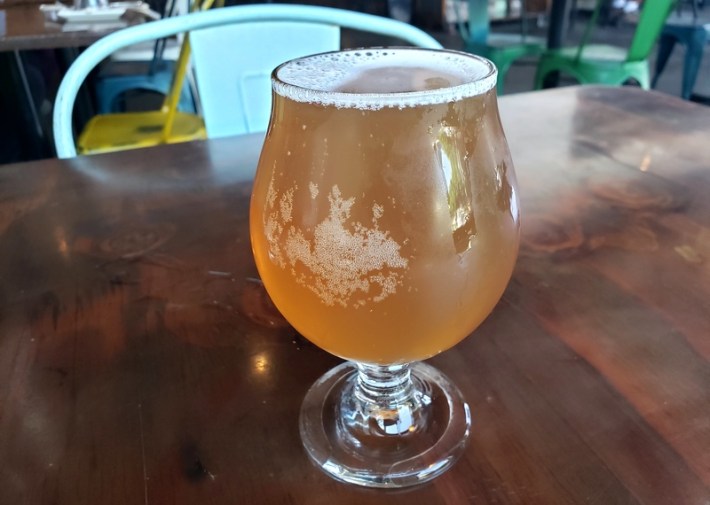 A glass of Orange Creamsicle kombucha from Sage Brew