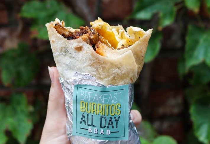 the "Basic Bae-con" breakfast burrito, with a bite taken out