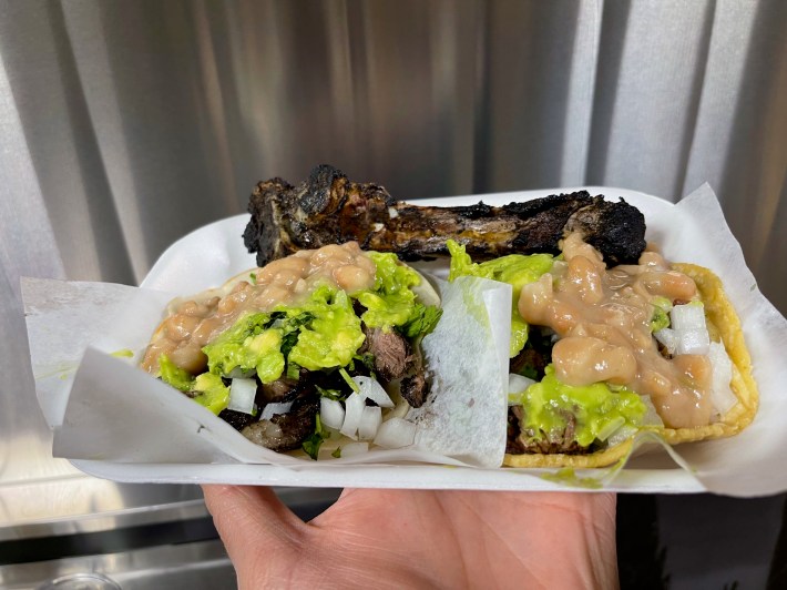 Mochomitos tacos de costilla served with a grilled rib bone, and topped with guacamole, cilantro, onion and their velvety beans. Photo by Javier Cabral for L.A. TACO.
