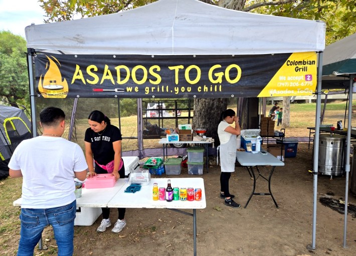 A cashier taking orders at Asados To Go