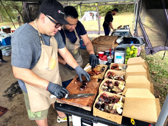 Sausage maker Andres helping prepare asado boxes at Asados To Go.