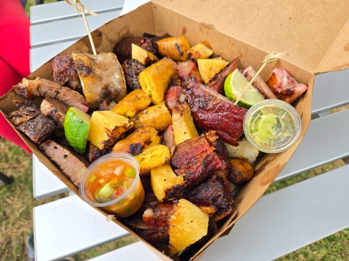 A cardboard box full of Colombian meats and fruits.