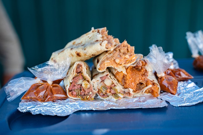 Burrito de papa con carne on the bottom left, chicharron on the right, and bistec on top of the igloo.