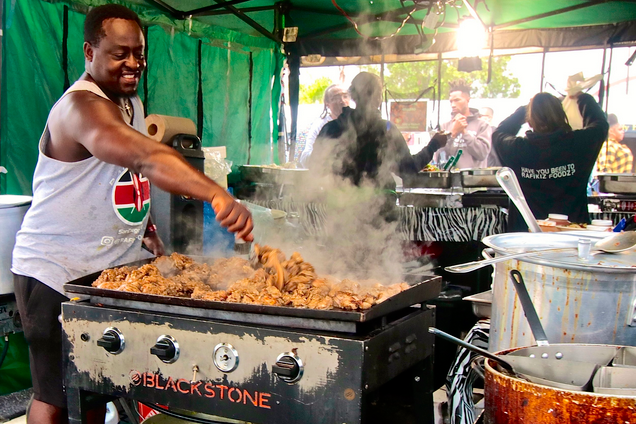 Sylvester Owino of Rafikiz Foodz standing over a hot grill at L.A.'s Taste of Soul festival.