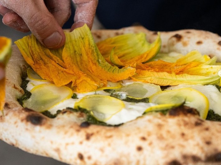 The Gialla pizza with pesto genovese, stracciatelle, squash blossom, and lemon zest at Dante.