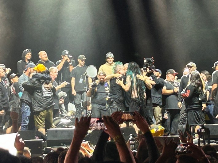 The members of NOFX hug before onlookers after playing their final live show in San Pedro, CA,