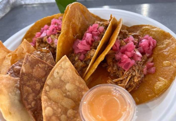 Cochinita pibil tacos with chips and salsa habanero.