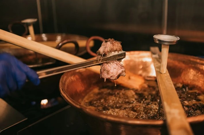 A copper cazo being used for carnitas at L.A.'s defunct Flaco.