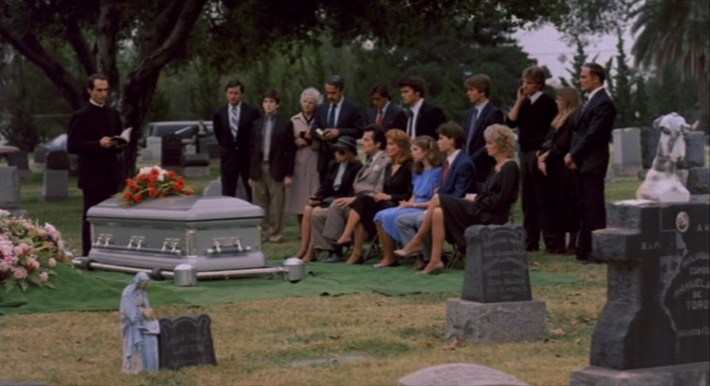 Nancy (center) and a small group of family and friends attend Rod Lane’s funeral. Screenshot via New Line Cinema.